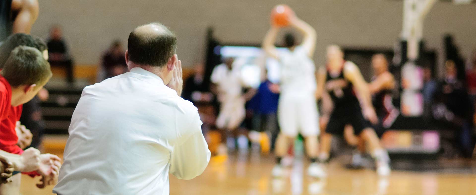 Coach Jim Psaras coaching a Rogers High School basketball game